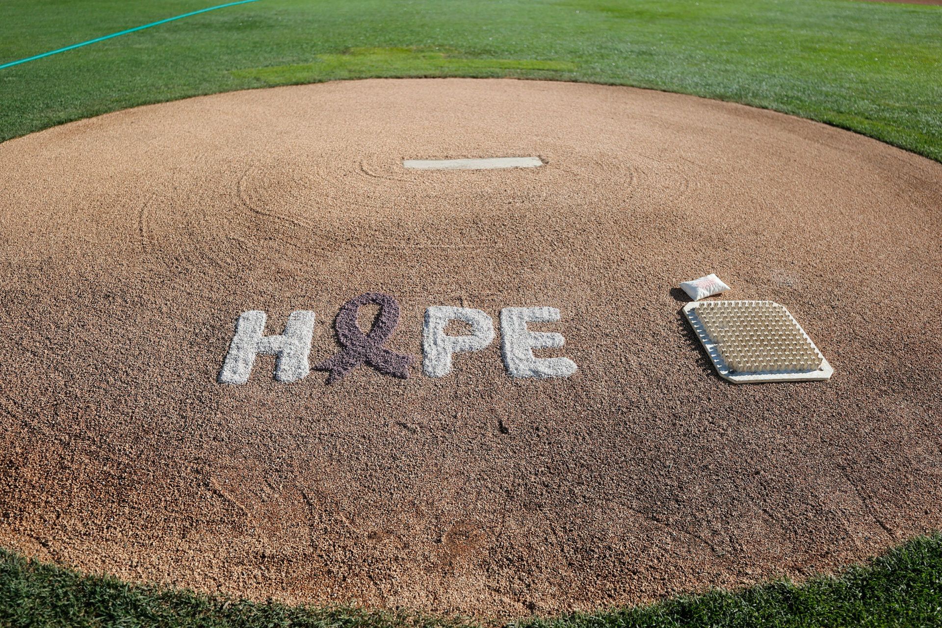 HOPE written into dirt of pitching mound HOPE written into dirt of pitching mound